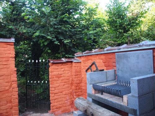a bench sitting next to a brick fence at Grote Goesting holiday house in Wevelgem