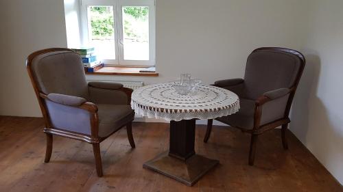 a table with two chairs and a table with at Uspokój Ducha - Adults only in Stara Morawa