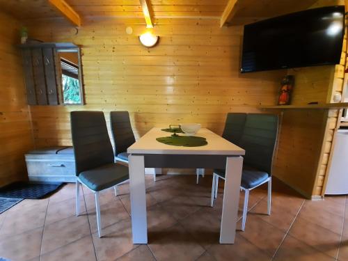 a dining room with a table and chairs in a cabin at DOMKI RODIS in Baligród
