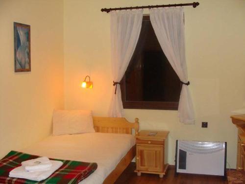 Habitación pequeña con cama y ventana en Madara OMAYA Guest House, en Madara