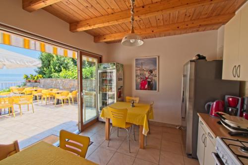 a kitchen and dining room with a table and chairs at Guesthouse Opara in Piran