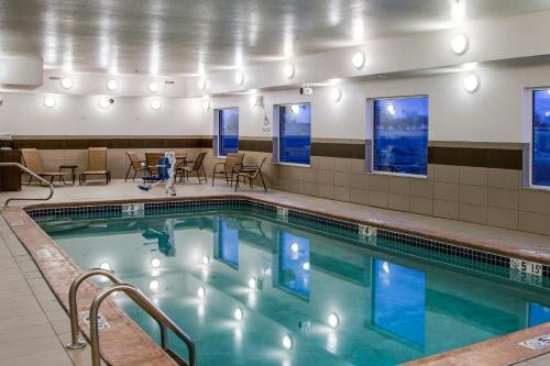 a swimming pool with a person standing in front of it at Holiday Inn Express & Suites Nevada, an IHG Hotel in Nevada