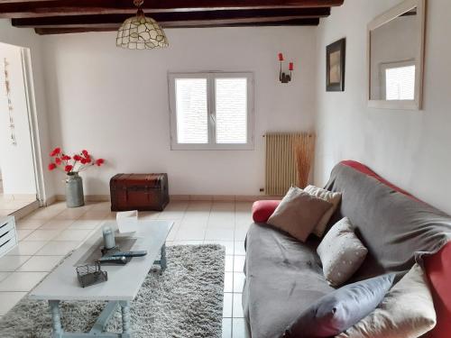 a living room with a couch and a table at AMBROGIO in Amboise
