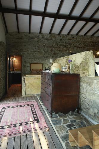 a room with a counter and a stone wall at CASA da PISCINA, Quinta do Espinho, Douro Valley in Tabuaço