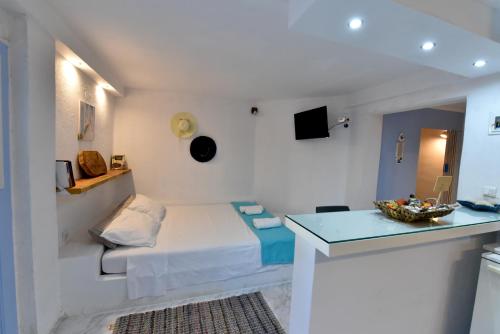 a small room with a bed and a table at jasmine apartments in Eretria