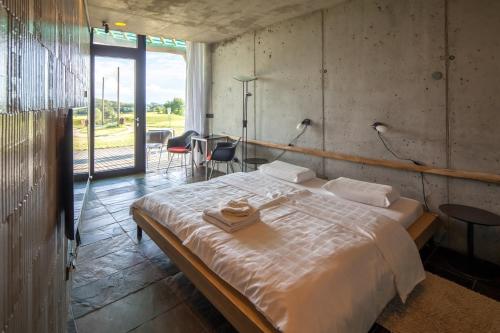 a bedroom with a large bed with two towels on it at Golf Čertovo břemeno in Jistebnice