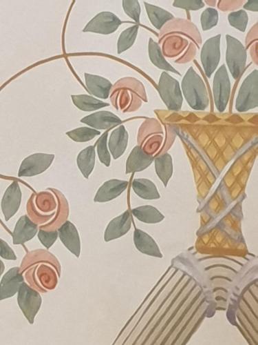 a drawing of a vase with roses on a wall at varcOrtigia Bed and Breakfast in Siracusa