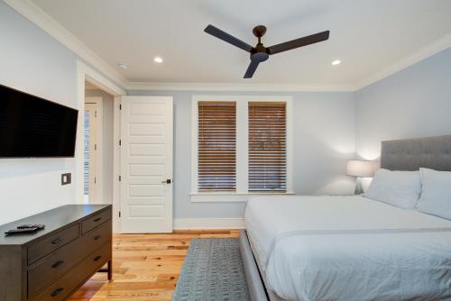 a bedroom with a bed and a ceiling fan at The Quarters on King in Charleston