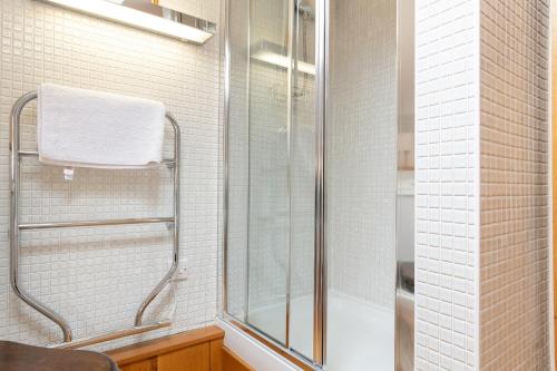 a bathroom with a shower with a glass door at Finest Retreats - The Cottage - Luxury 1 Bed Cottage in Rhydymwyn