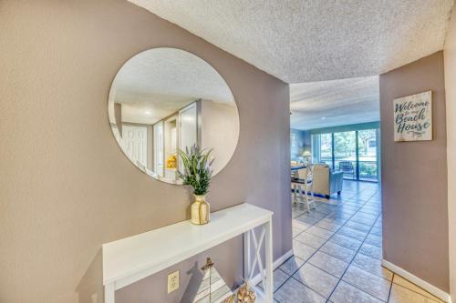 a hallway with a mirror and a table with a vase at Shorewalk Full Condo Lake view Near to Beach IMG in Bradenton