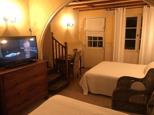 a bedroom with a bed and a television in a room at La Marjolaine in Juan-les-Pins