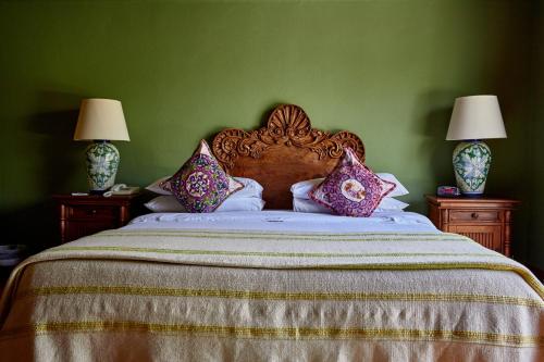 
a bed with a white comforter on top of it at La Puertecita Boutique Hotel in San Miguel de Allende
