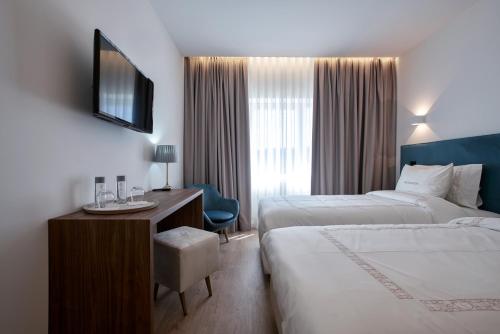 Ein Bett oder Betten in einem Zimmer der Unterkunft Hotel Moutados