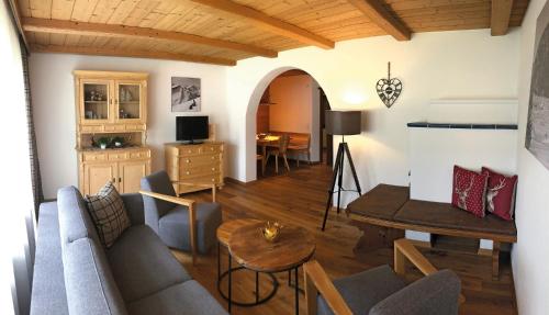 a living room with a couch and a table at Ferienwohnungen Meusburger in Tannheim