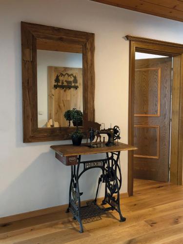 a table in a room with a mirror on the wall at Ferienwohnungen Meusburger in Tannheim