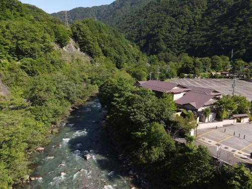 an aerial view of a river next to a mountain at Keiryuso Siorie in Matsumoto