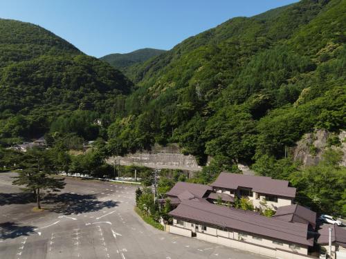an aerial view of a mountain with a parking lot at Keiryuso Siorie in Matsumoto