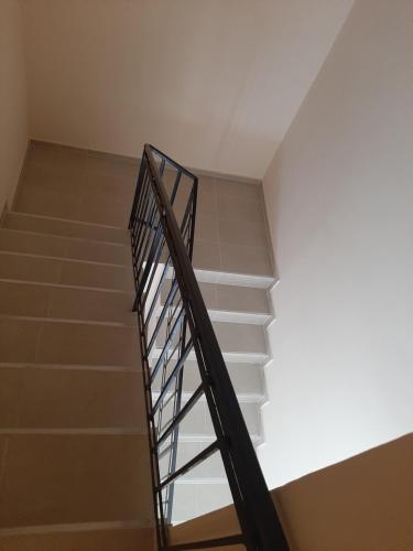 a staircase with a metal railing in a building at Megyeri Apartman in Pócsmegyer