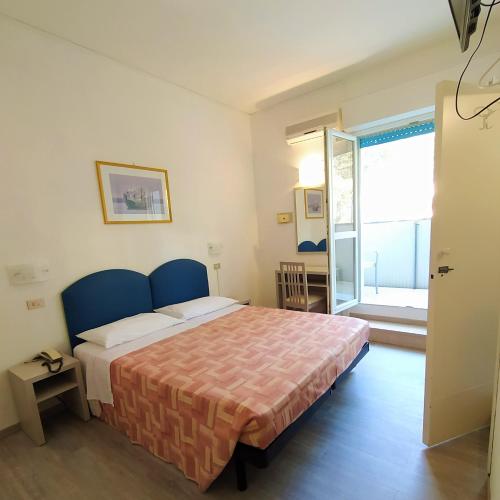 Postel nebo postele na pokoji v ubytování Hotel Capri
