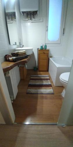 a bathroom with a sink and a tub and a toilet at Piccola Perla sul Lago Maggiore in Arona