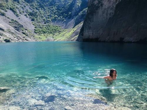 a woman swimming in a body of water at New Holiday House, near Makarska in Grubine