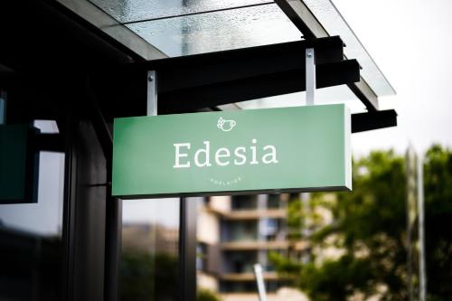 a green sign hanging from the side of a building at Avani Adelaide Residences in Adelaide