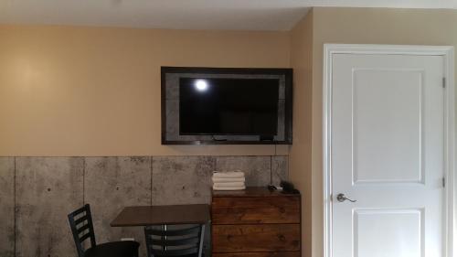 a room with a flat screen tv on the wall at Blue Moon Motel in Niagara Falls