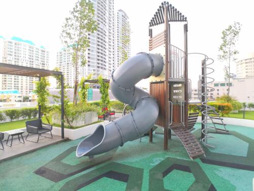 a slide in a playground in a city at The Landmark by Comfy in George Town