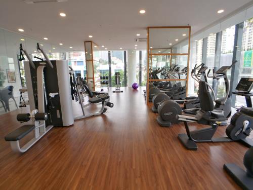 a gym with a bunch of treadms and cardio machines at The Landmark by Comfy in George Town