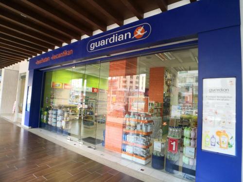 a store front of a grocery store with a large window at The Landmark by Comfy in George Town