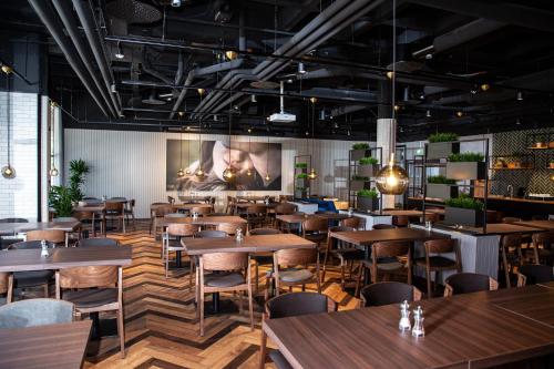 a dining room with wooden tables and chairs at Original Sokos Hotel Lappee in Lappeenranta
