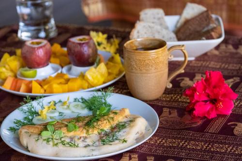 a table with plates of food and a cup of coffee at Jasmin Garden Koh Kood in Ko Kood