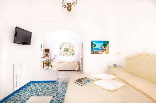 a living room with a couch and a tv at Casa Guadagno in Positano