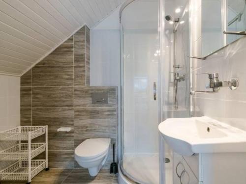 a bathroom with a shower and a toilet and a sink at Pokoje gościnne Bartek in Białogóra