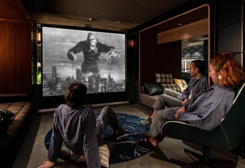 a group of people sitting in a room watching a movie at THE LIVELY FUKUOKA HAKATA in Fukuoka