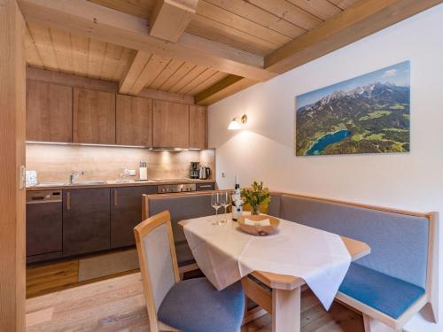 a kitchen and dining room with a table and chairs at Pension Hinterholzer in Scheffau am Wilden Kaiser