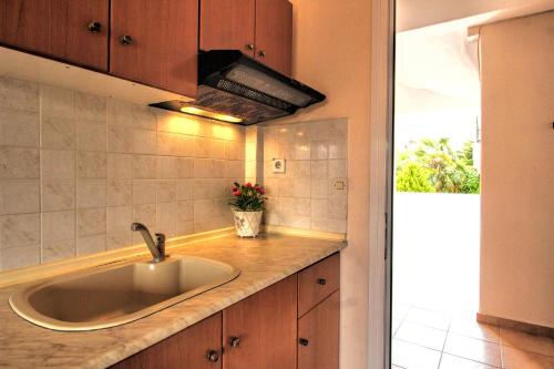 a kitchen with a sink and a counter top at GOLDEN SUN STUDIOS in Kallithea Halkidikis