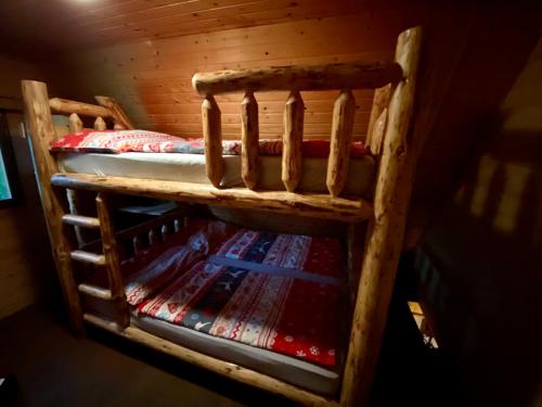 a wooden bunk bed with a rug on it at Morávka chalupa in Morávka