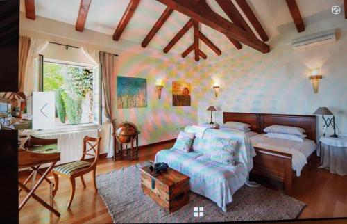a bedroom with a bed and a desk and a table at Peace of mind N 3 in Poljane