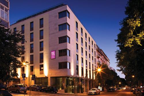 a large building on a city street at night at NEYA Lisboa Hotel in Lisbon
