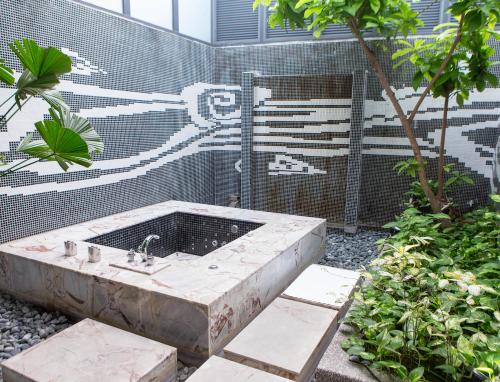 a bath tub with a sink in a garden at All-Ur Boutique Motel - KaoHsiung Branch in Kaohsiung