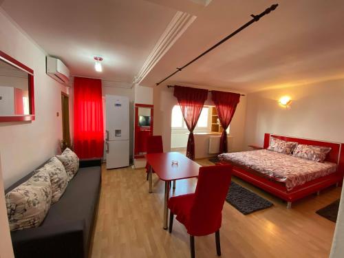 a living room with a bed and a table and chairs at Faleză nord in Constanţa