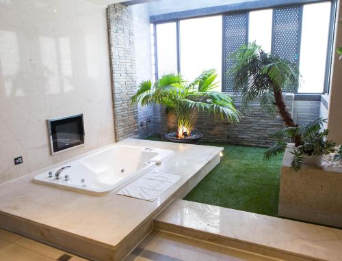 a large bathroom with a tub and plants in it at All-Ur Boutique Motel - KaoHsiung Branch in Kaohsiung