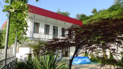 a white building with a red roof at Villa Near The Batumi in Batumi