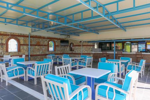 a restaurant with blue and white tables and chairs at Sunset Village in Didim