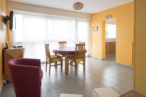 a dining room with a table and chairs at MARTY in Fécamp