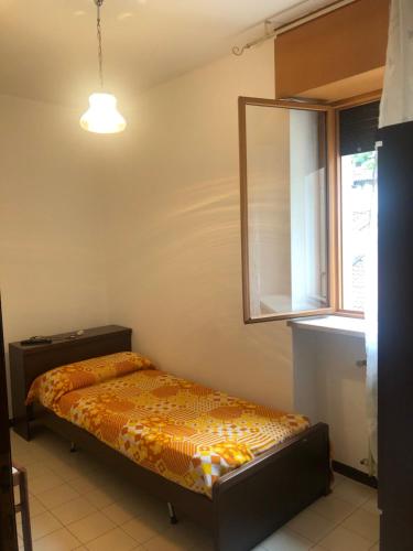 a bed in a room with a mirror and a window at Caffè Martini in Arsiero