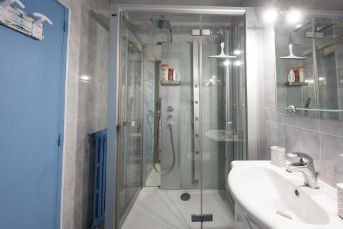 a bathroom with a glass shower and a sink at MARTY in Fécamp