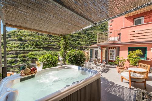 a hot tub on the patio of a house at La Torretta Lodge in Manarola