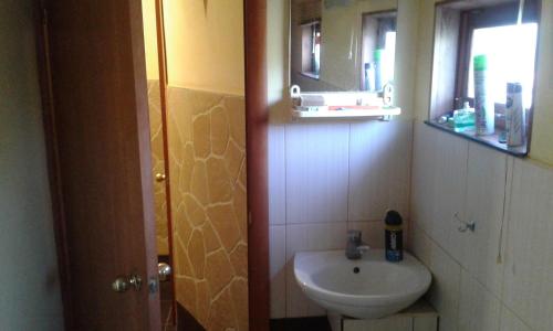 a small bathroom with a sink and a mirror at Одноместный номер in Odesa